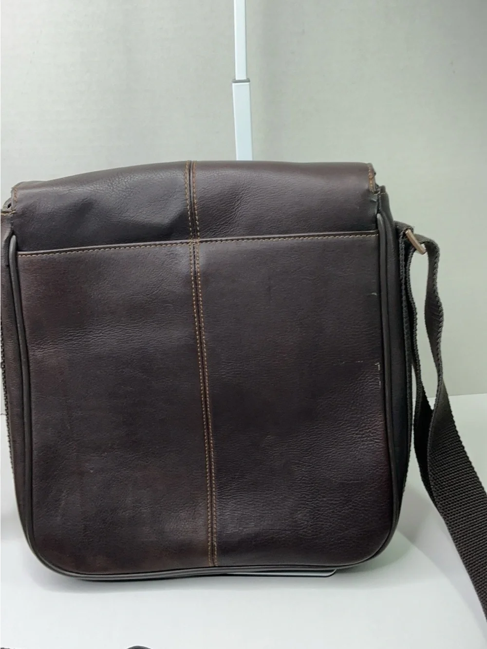 Kenneth Cole Reaction dark brown leather messenger-style tablet bag.